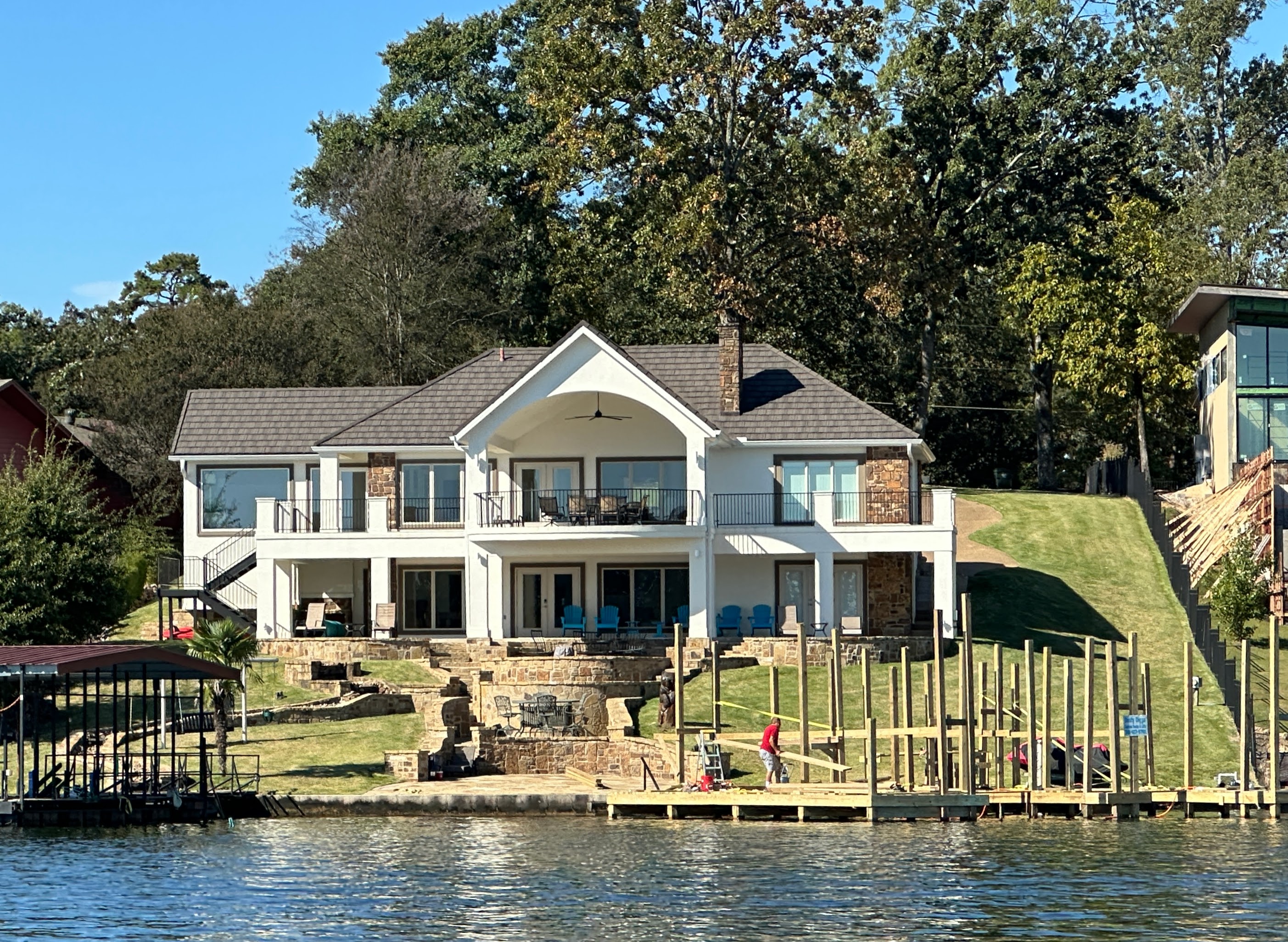 Classic white lakefront home with dock on Lake Hamilton
