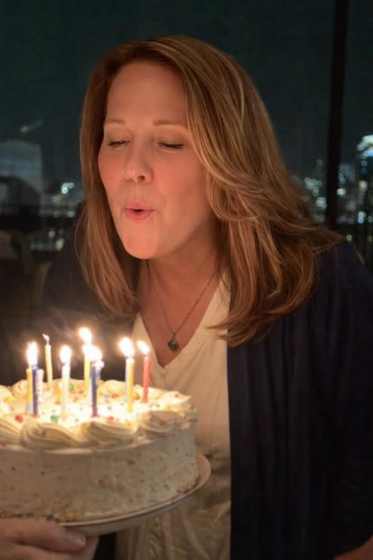 Nancy Bergeron blowing out birthday candles